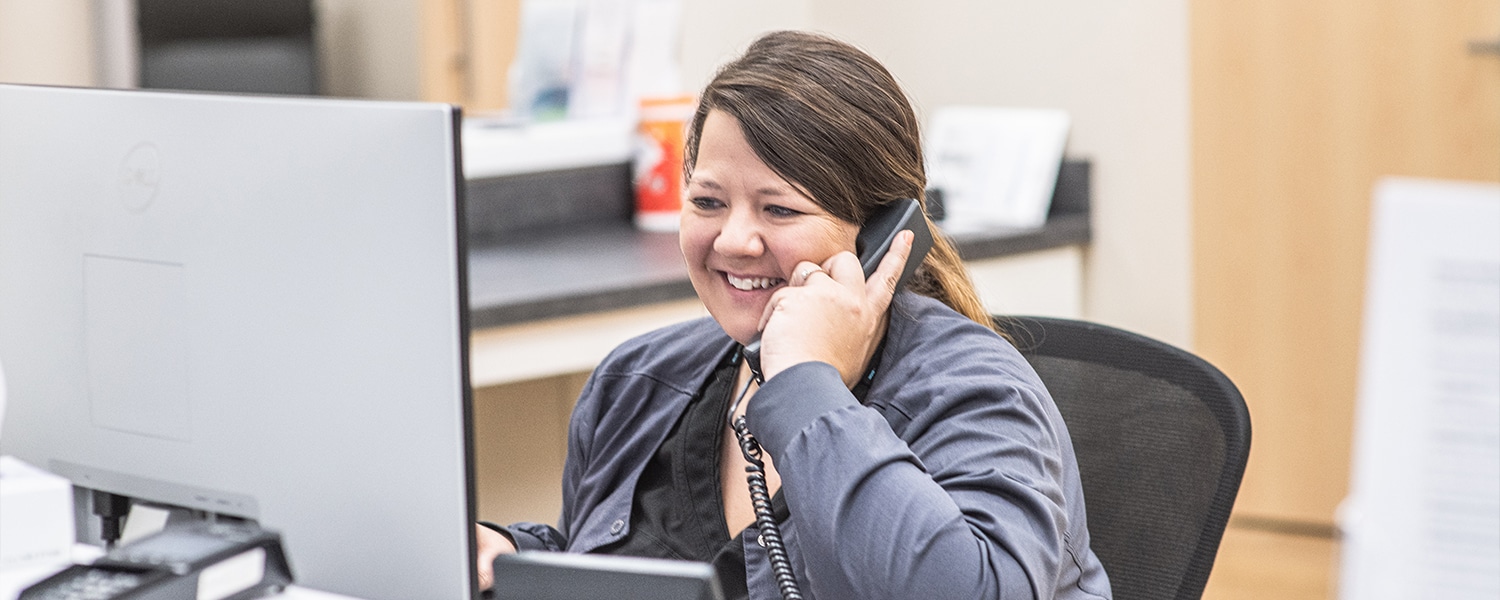 Office worker speaking to a patient